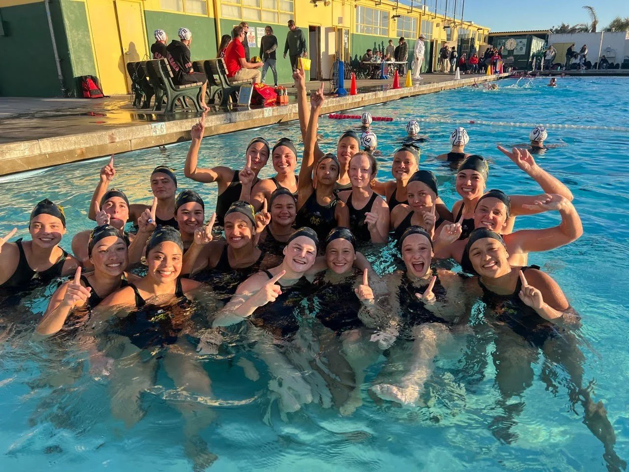Mira Costa Girls Water Polo team celebrating in the pool