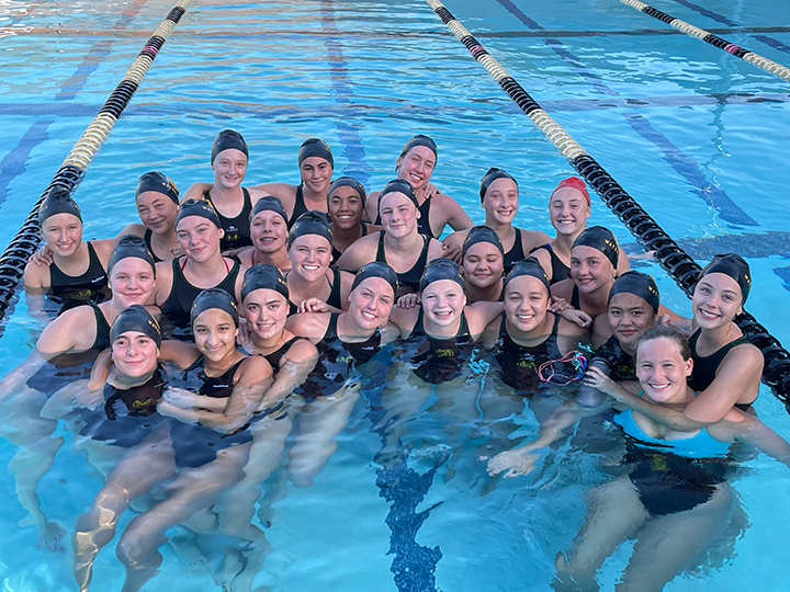 Mira Costa Girls Water Polo team gathered between pool lanes
