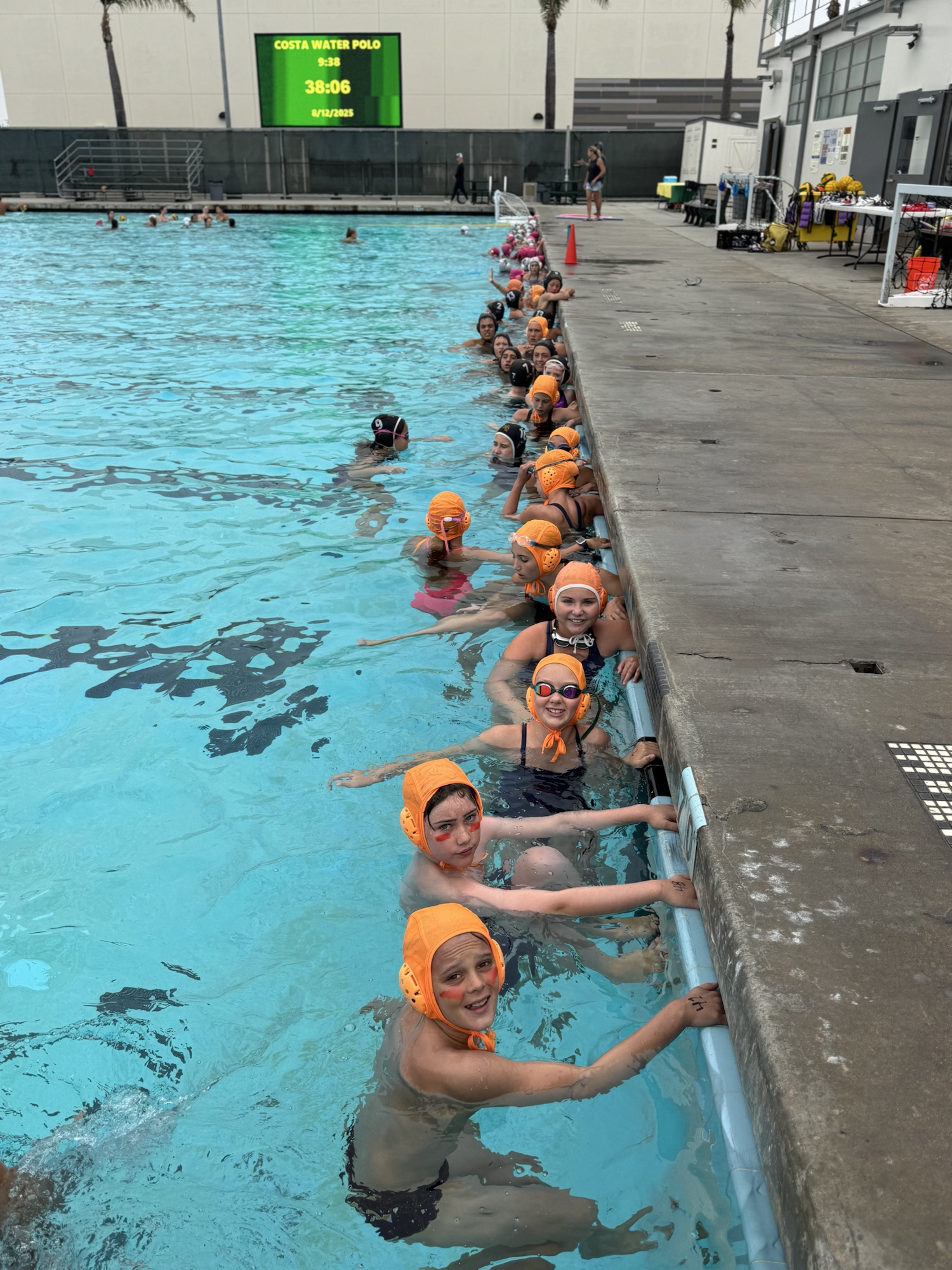 Mini Mustangs athletes lined up at the pool wall